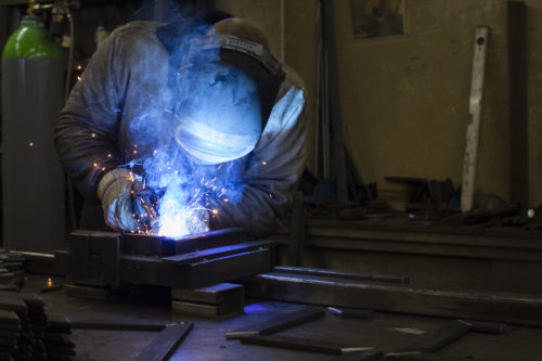 worker performing welding