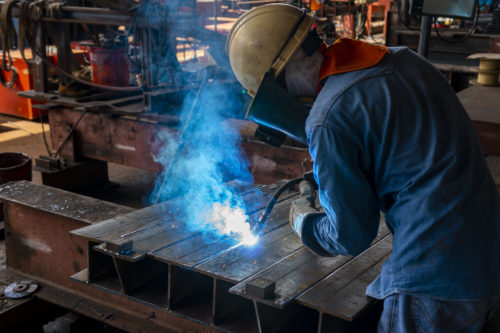 Man welding in a machine shop